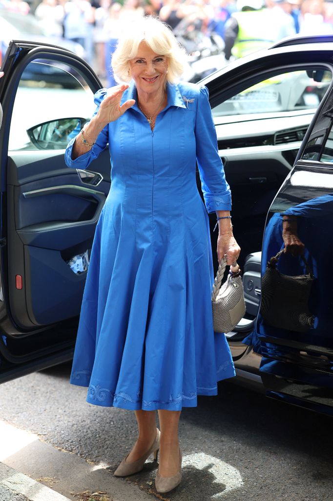 Queen Camilla waves as she arrives 