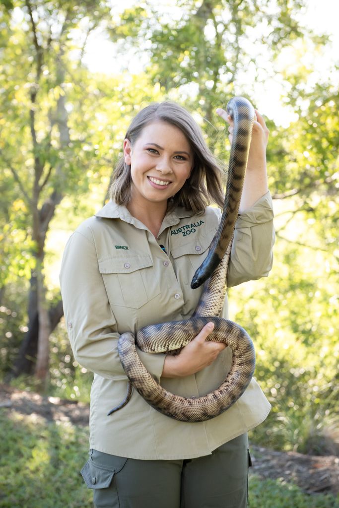 Bindi Irwin holds a snake at Australia Zoo