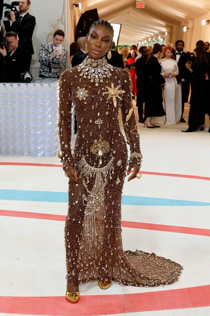 Michaela Coel looked exquisite in an embellished custom Schiaparelli ensemble, topped off with statement jewels by Emefa Cole in SMO Gold, (the first transparent and traceable gold).