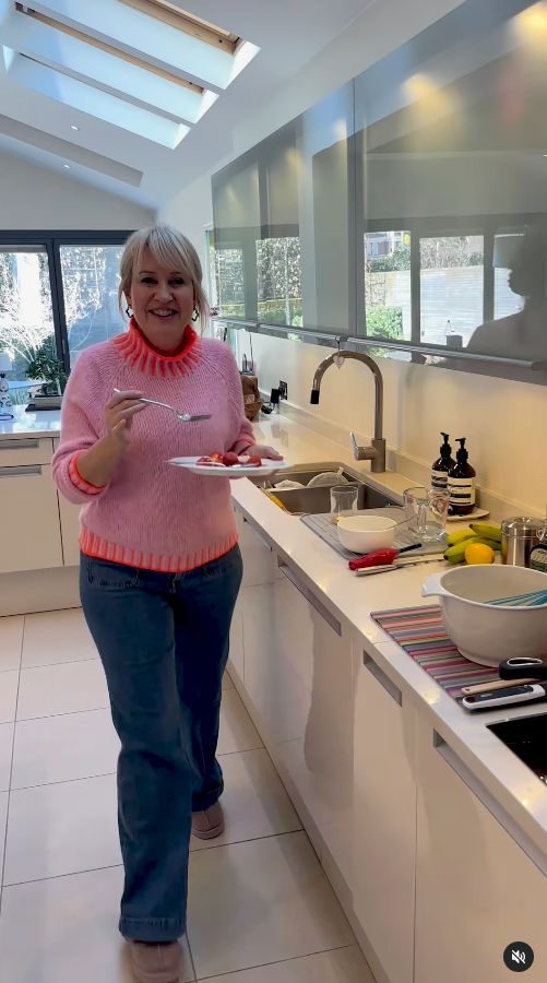 Nicki Chapman eating a pancake in her kitchen