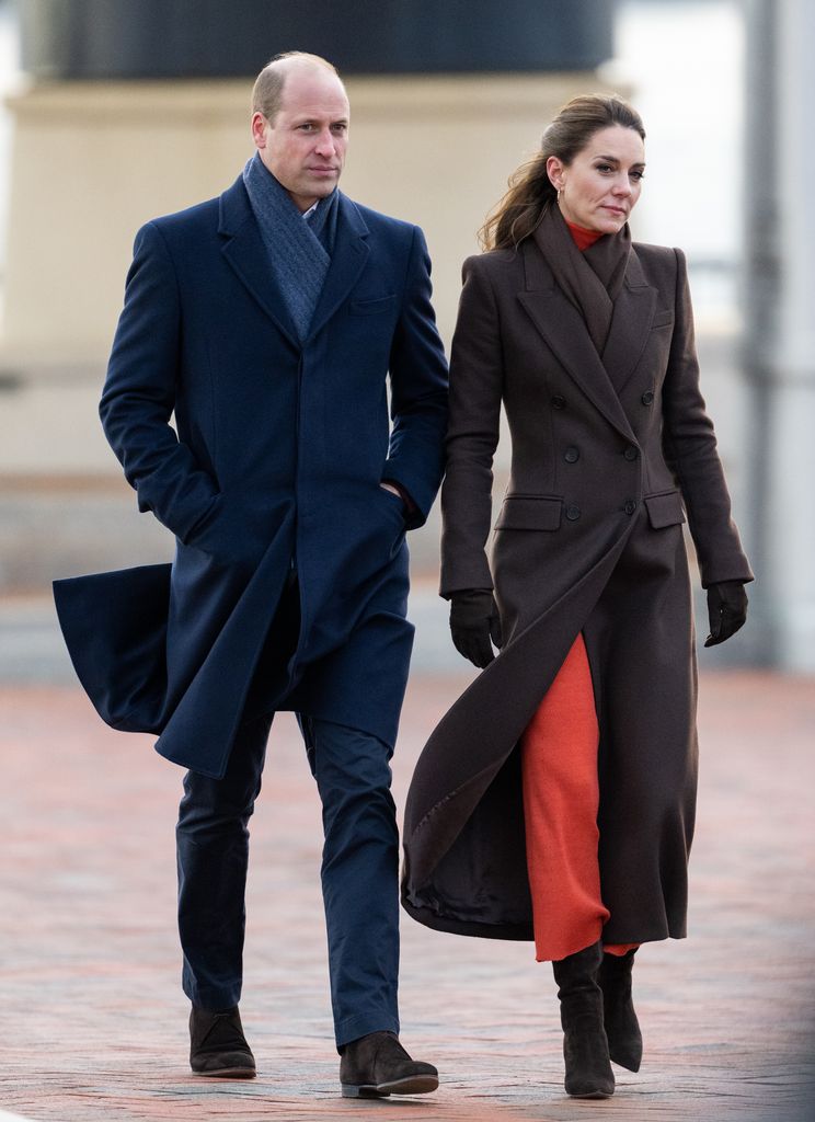 Kate in brown coat walking beside william