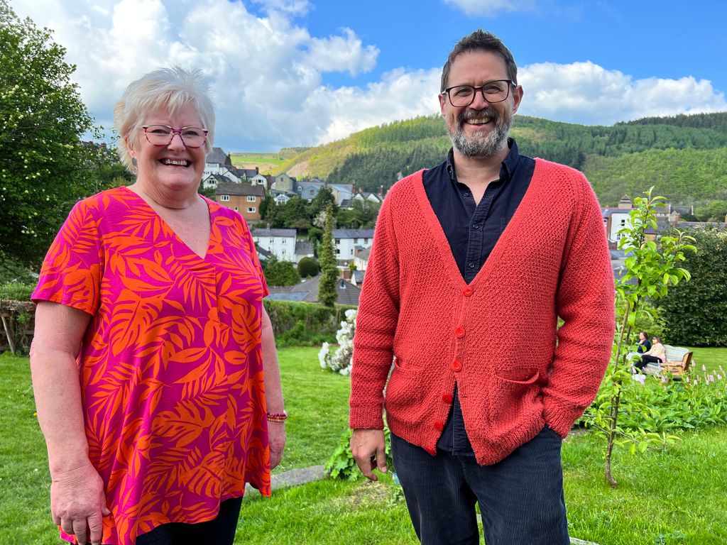 Alistair Appleton in a red jumper and denim outfit