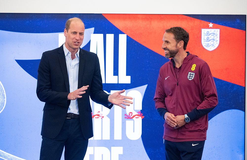 England manager Gareth Southgate (R) listens as Prince William chats to the England team