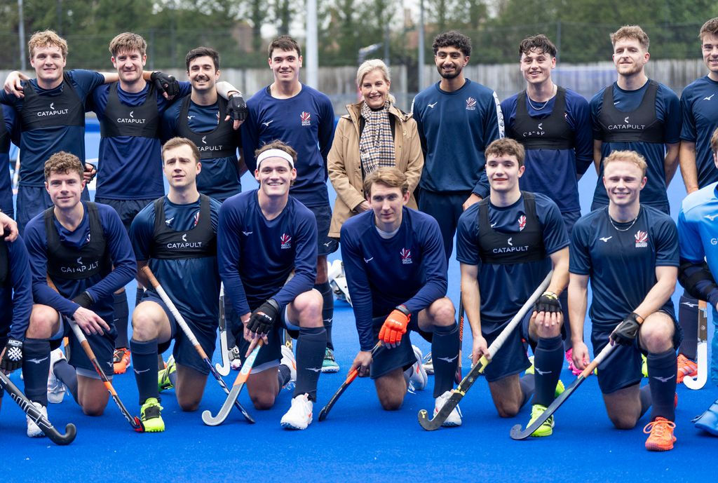 Sophie poses with the GB Men's Senior Team during her visit to England Hockey