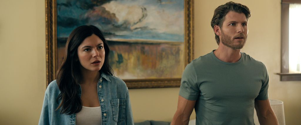 young woman and man standing in house