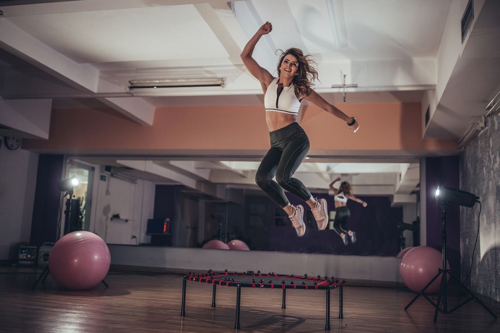 Woman jumping on mini trampoline