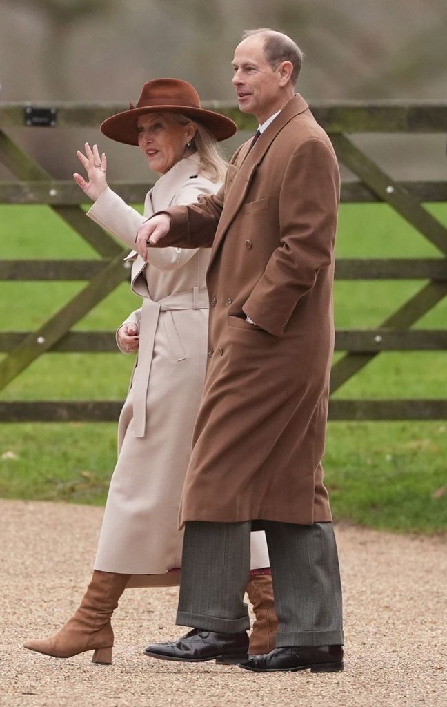 The Duke and Duchess of Edinburgh waving in tan coats