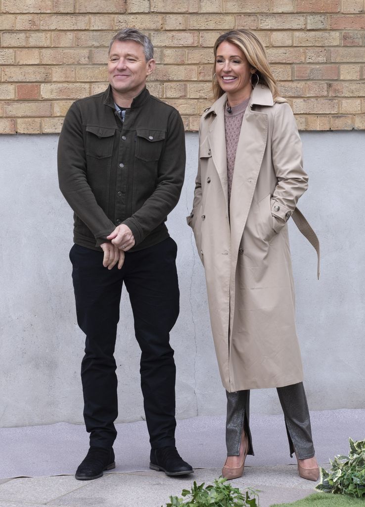 Cat in a trench coat outside with Ben Shephard