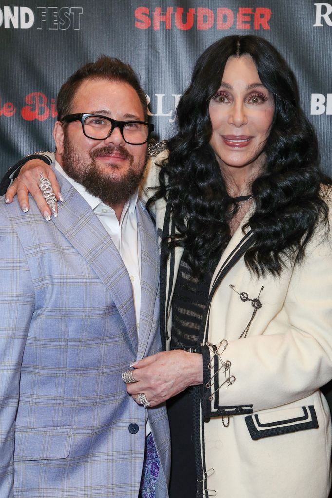 Chaz Bono and Cher smiling on the red carpet