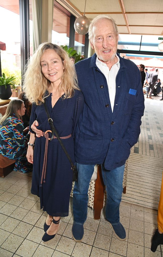 Alessandra Masi and Charles Dance snuggling close in navy outfits 