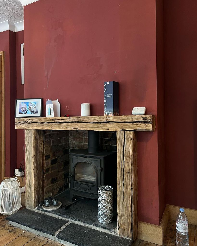 Fireplace against a red wall