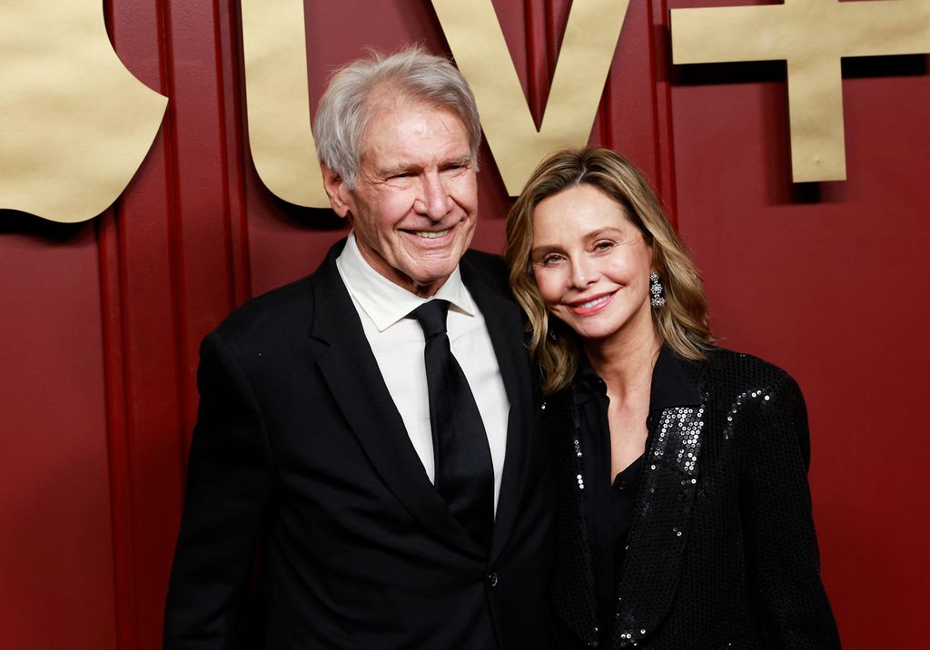 Harrison and his wife Calista Flockhart in front of red screen at Apple TV+ event