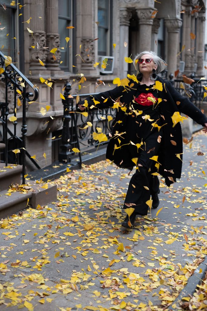 woman kicking autumn leaves 