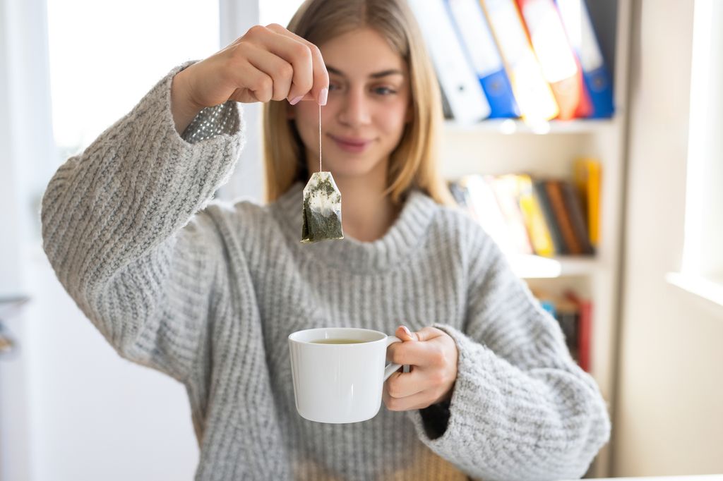 Woman hand holding a cup of tea