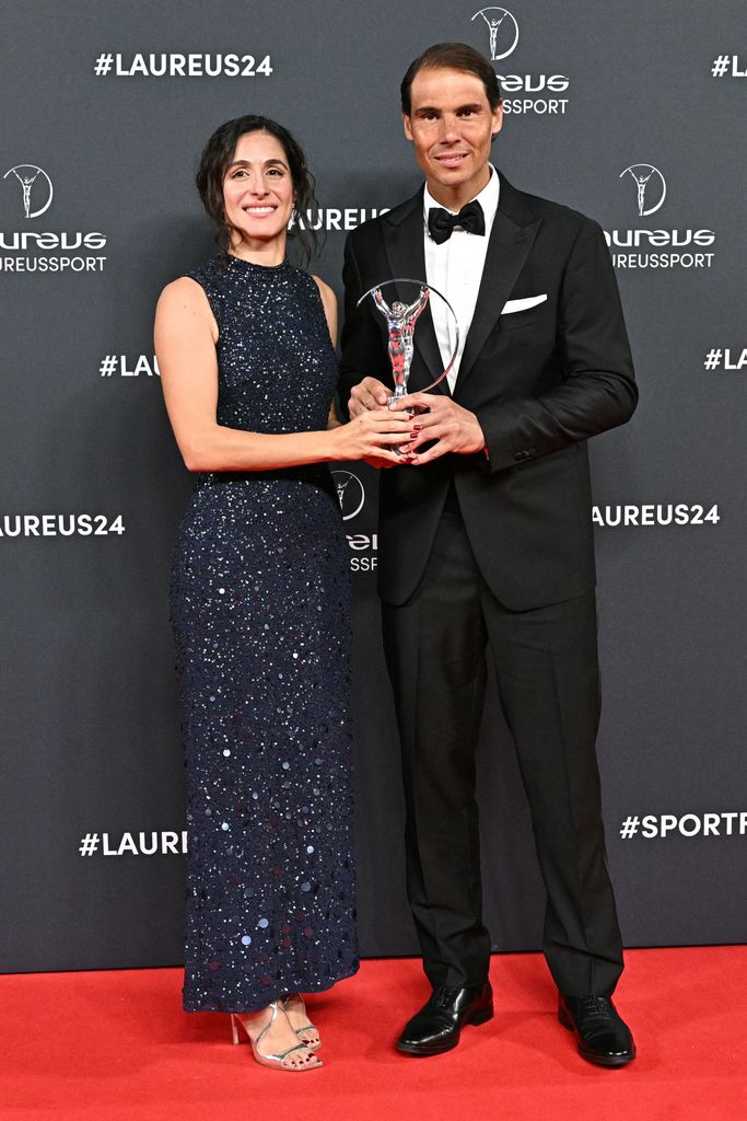 Rafa Nadal and wife Maria Francisca Perello hold award