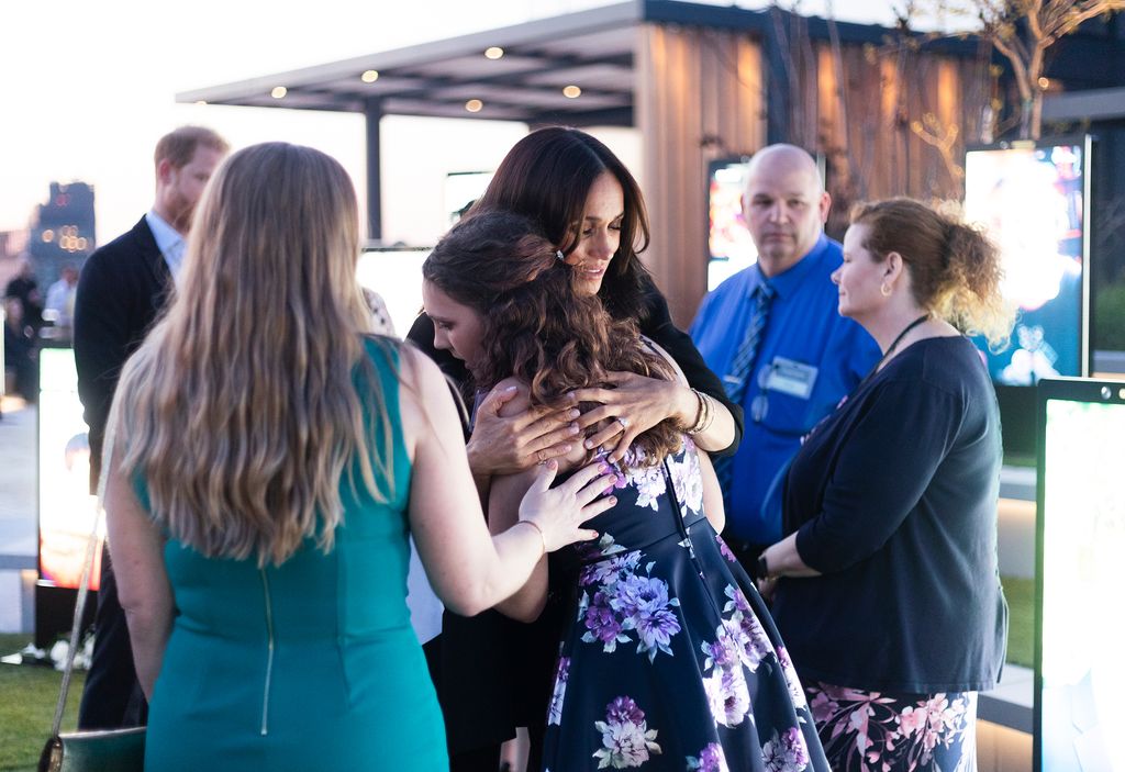 Meghan Markle hugging woman