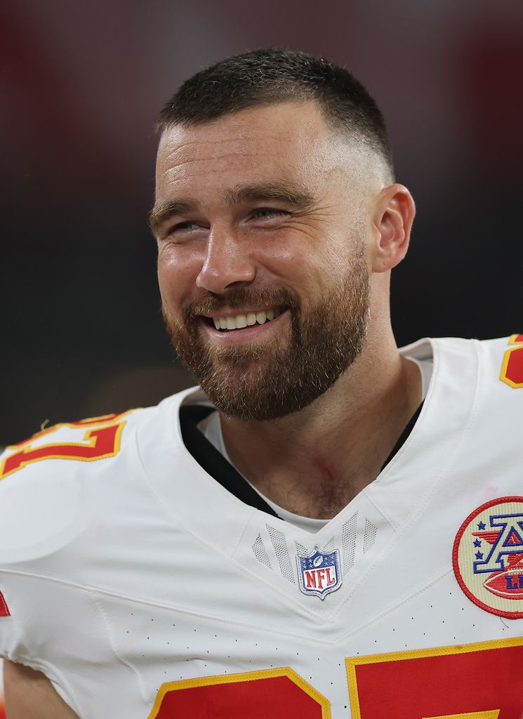 travis kelce smiling in chiefs uniform