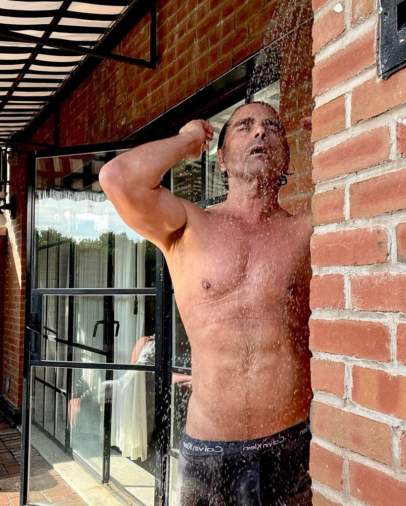 john stamos topless using outdoor shower