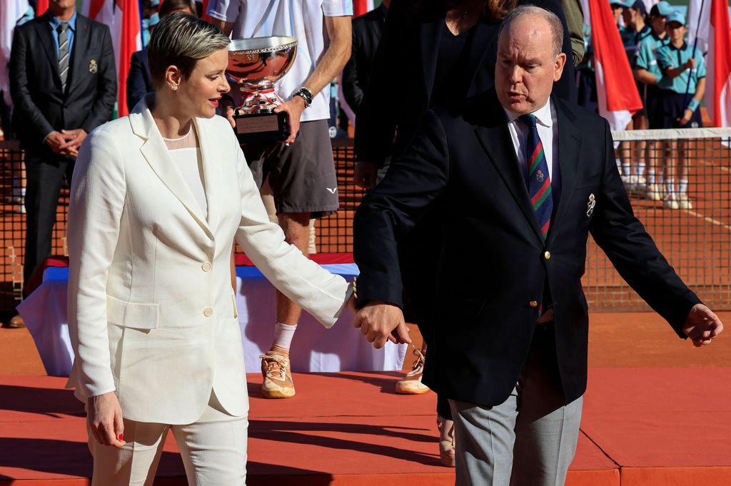 Charlene and Albert held hands as they stepped on the court