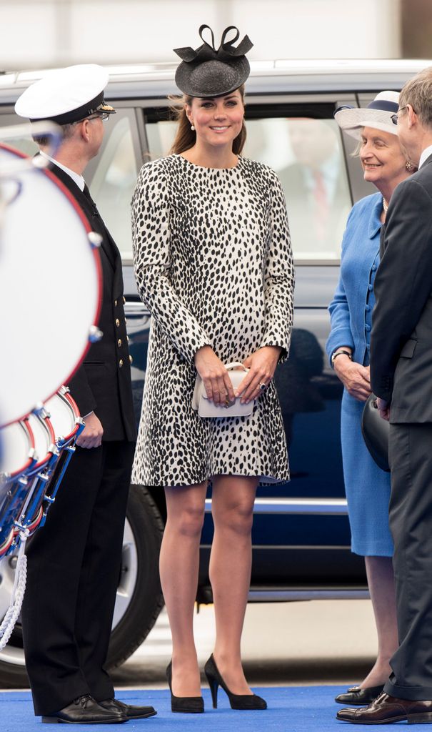 Catherine in dalmatian print dress smiling beside car