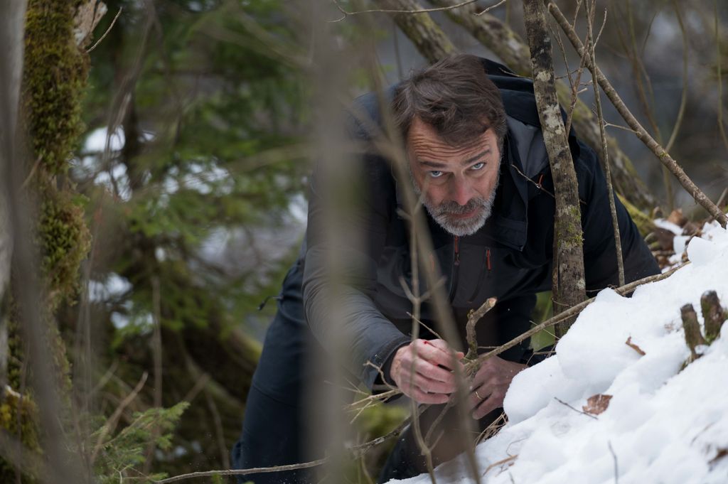 man crawling in snow