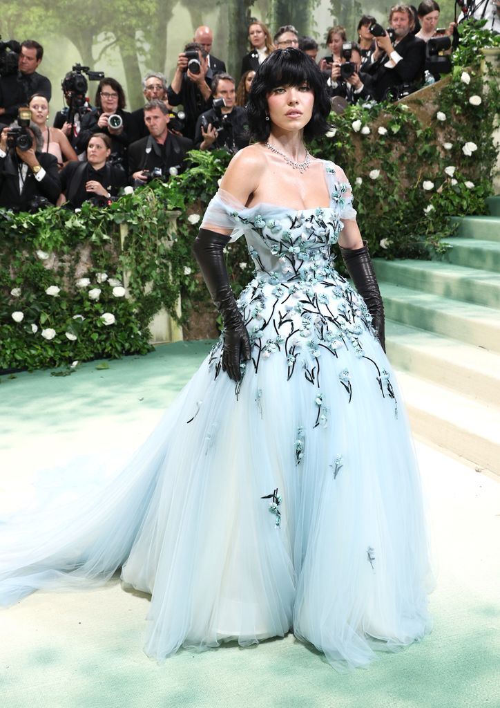 Sydney Sweeney attends The 2024 Met Gala in a blue dress and black wig