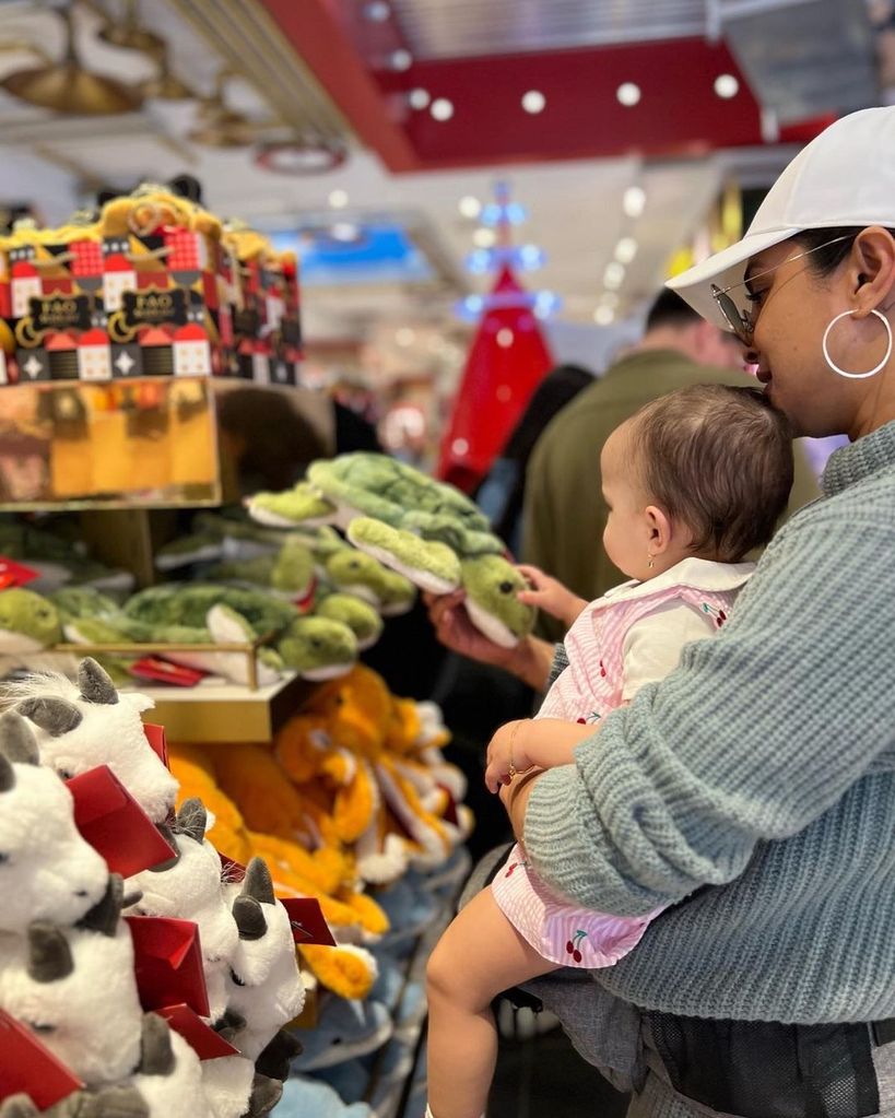 Priyanka Chopra cradles her baby Malti Marie in a toy store