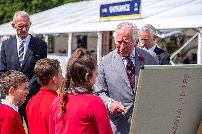 prince charles speaks with schoolchildren