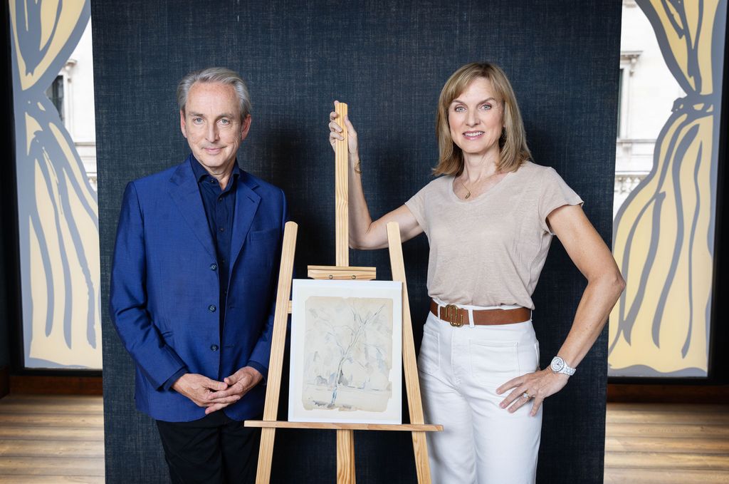 Philip Mould and Fiona Bruce with a painting