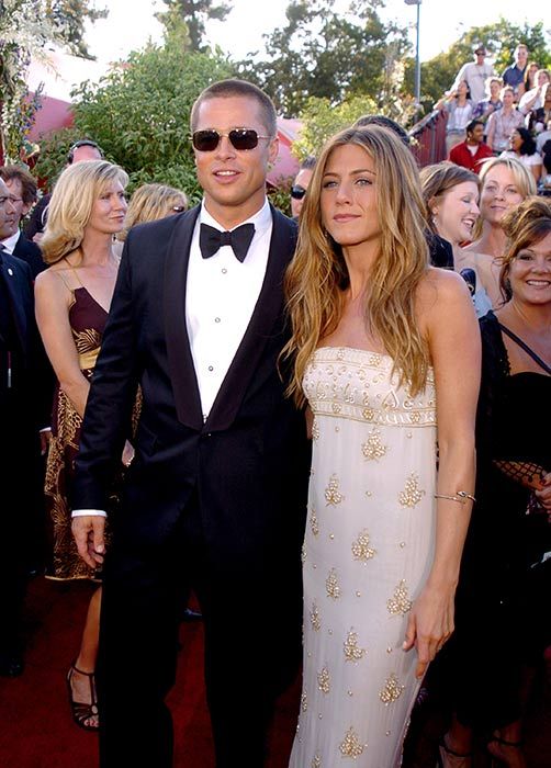 Jennifer Aniston wearing a long Chanel dress with Brad Pitt