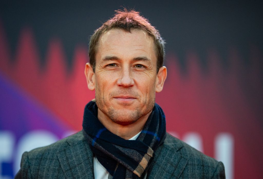 Tobias Menzies smiling in a check suit