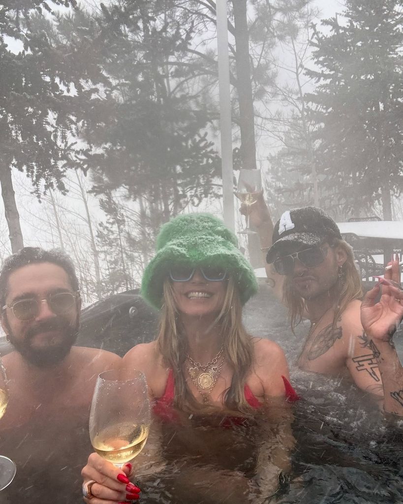 Heidi Klum in a red bikini in a hot tub in the snow