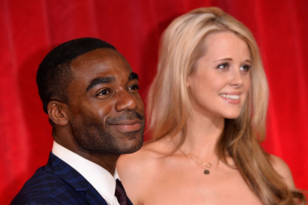 couple smiling on red carpet