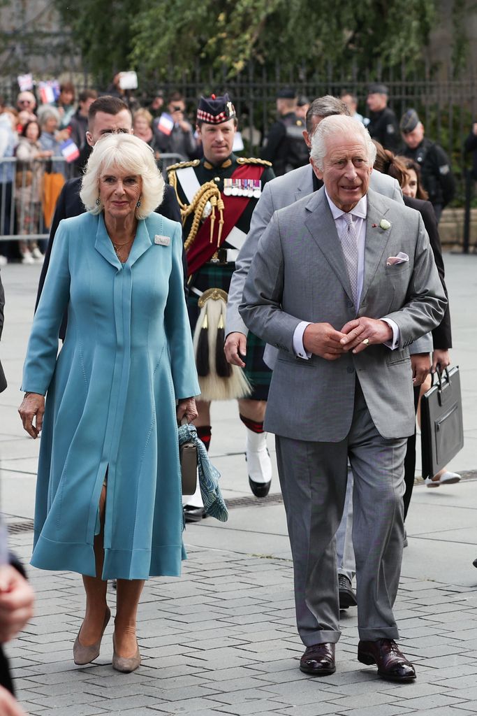 Lt Col Johnny Thompson is pictured walking behind Charles and Camilla in France