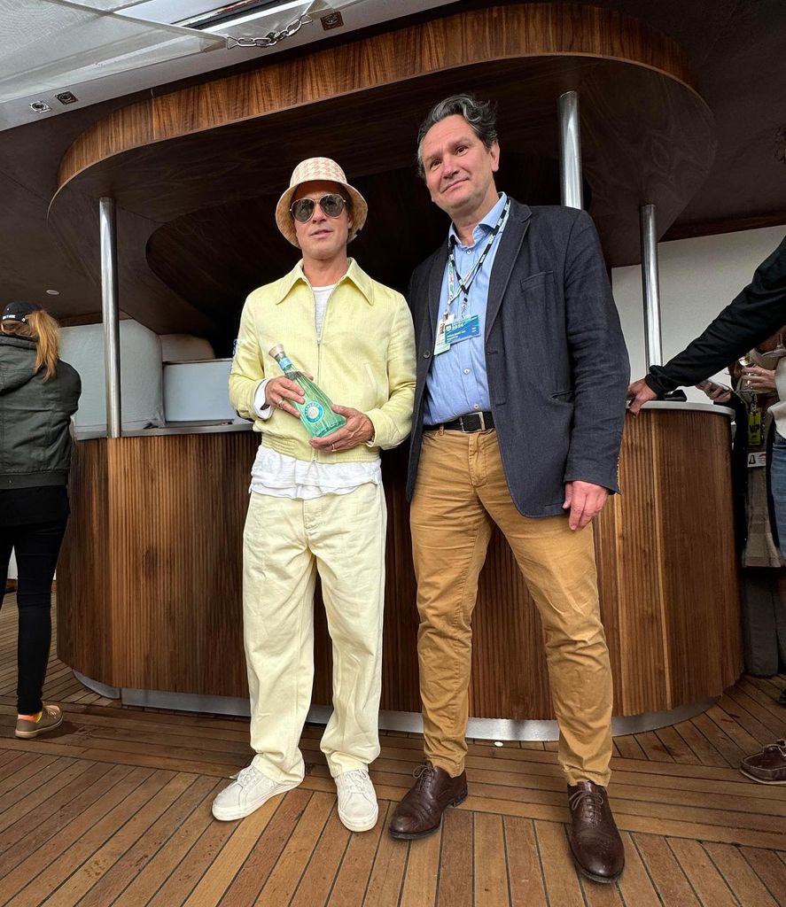 Brad Pitt dressed in yellow holds his gin brand “The Gardener”