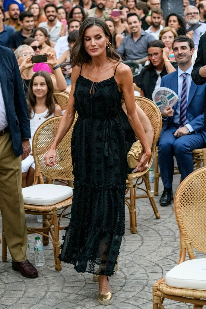 Queen Letizia of Spain in black dress and gold wedges 