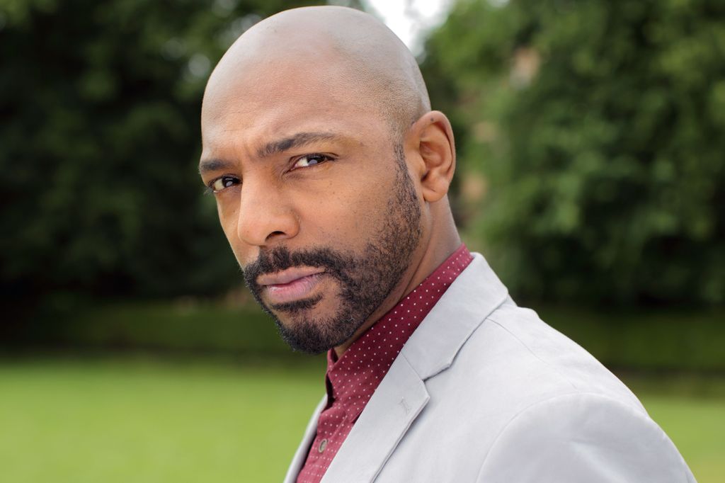 Man in suit staring down the camera