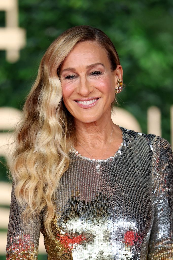 sarah jessica parker smiling in a silver dress