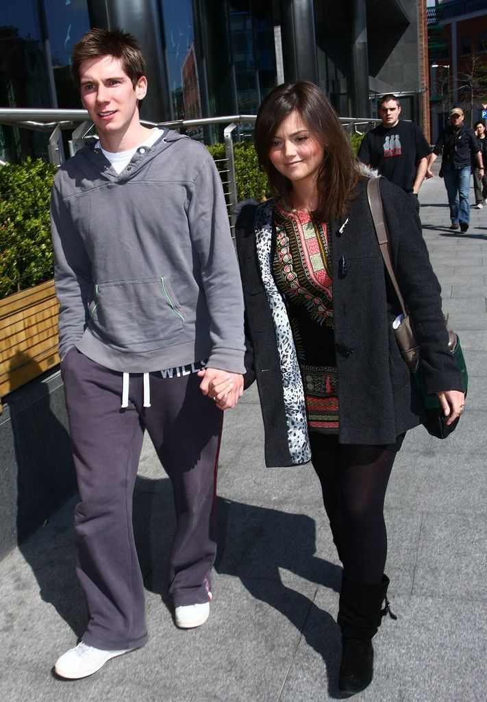 Karl Davies and Jenna Coleman holding hands