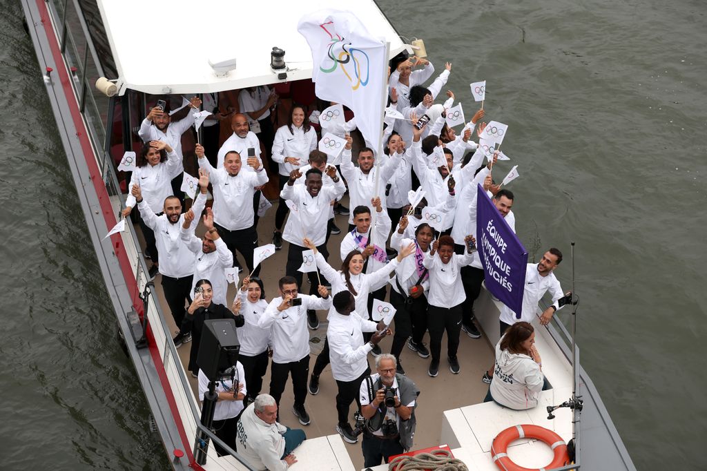 Refugee Olympic Team begins the athletes' parade past water jets and the water curtain under the Austerlitz Bridge on the Seine