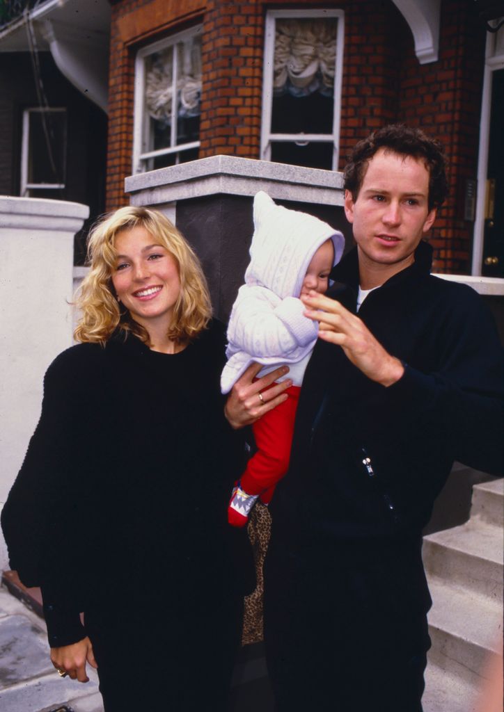 John McEnroe holds his son Kevin next to his then wife Tatum