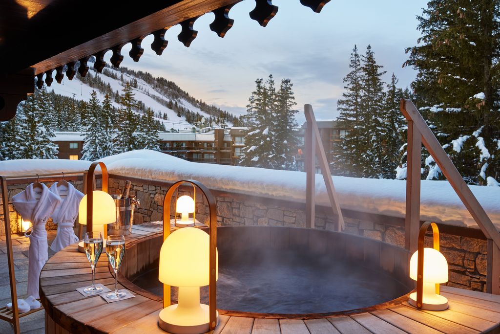 Les Airelles outdoor jacuzzi with lanterns at Courchevel 1850 