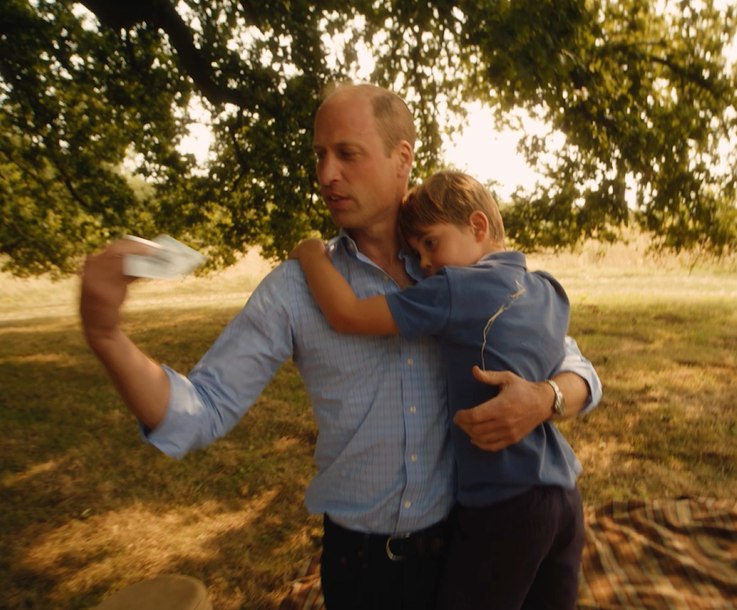 Prince William with his arm around Prince Louis