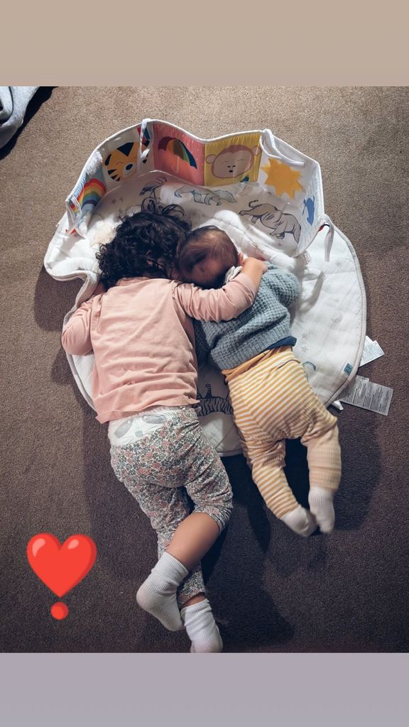 two siblings sharing cuddle on floor 