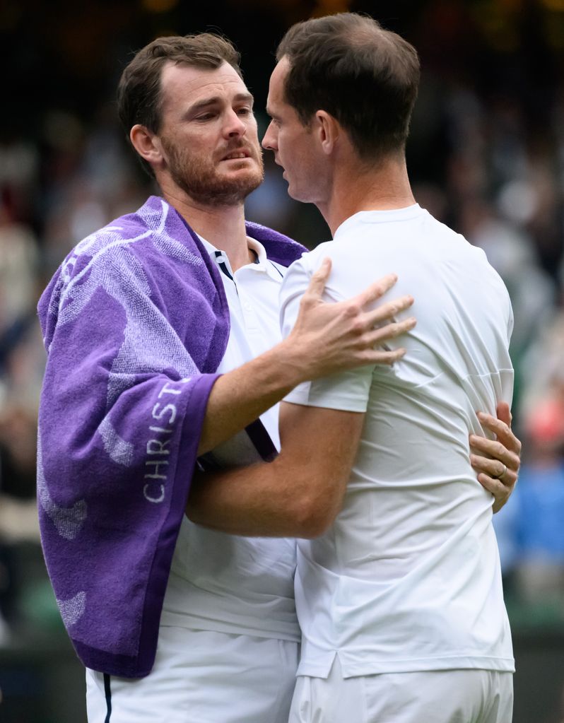 brothers hugging on tennis court 