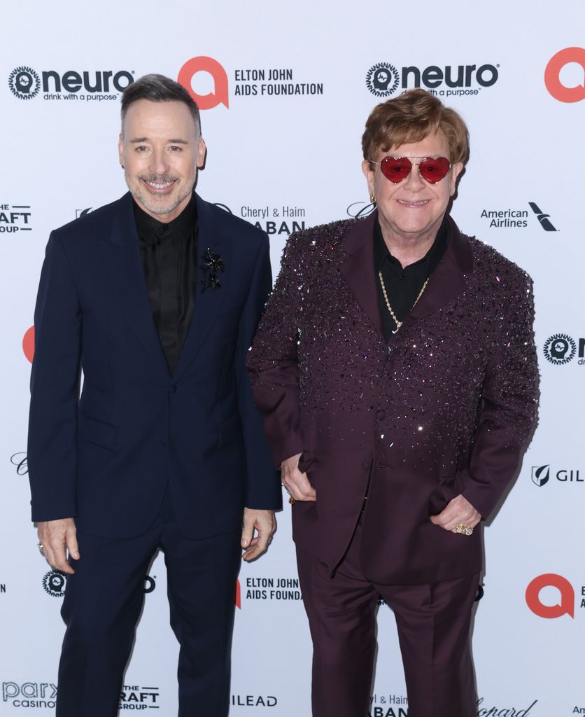 David Furnish standing with Elton John