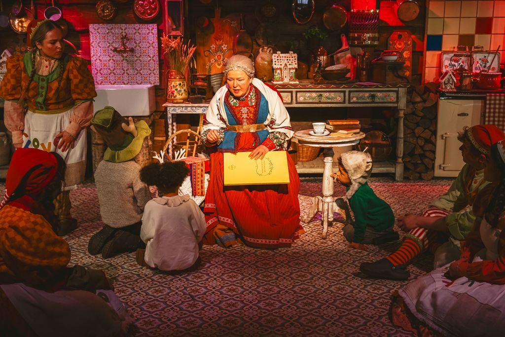 Mother Christmas treats children to a story after they've finished decorating their treats