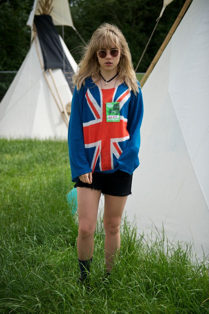 Suki Waterhouse is pictured during day 4 of the 2013 Glastonbury Festival wearing a Union Jack jumper and black denim shorts 