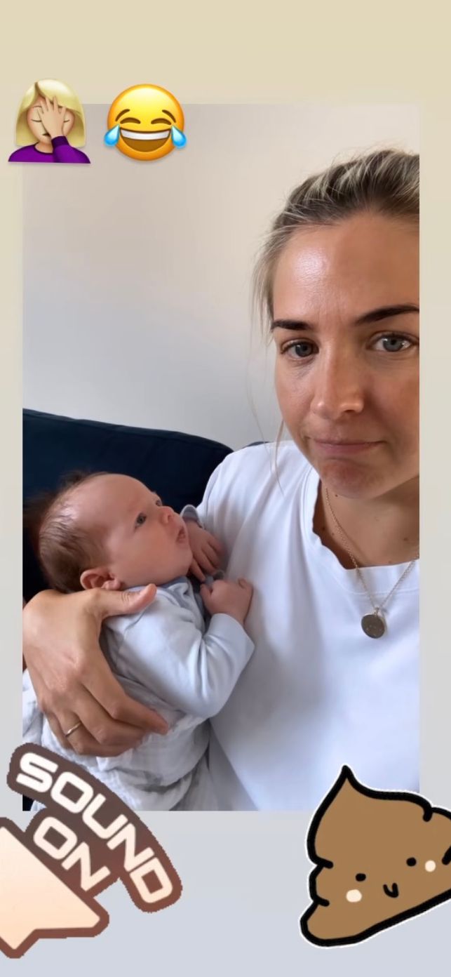 Gemma Atkinson holds her baby boy dressed in white