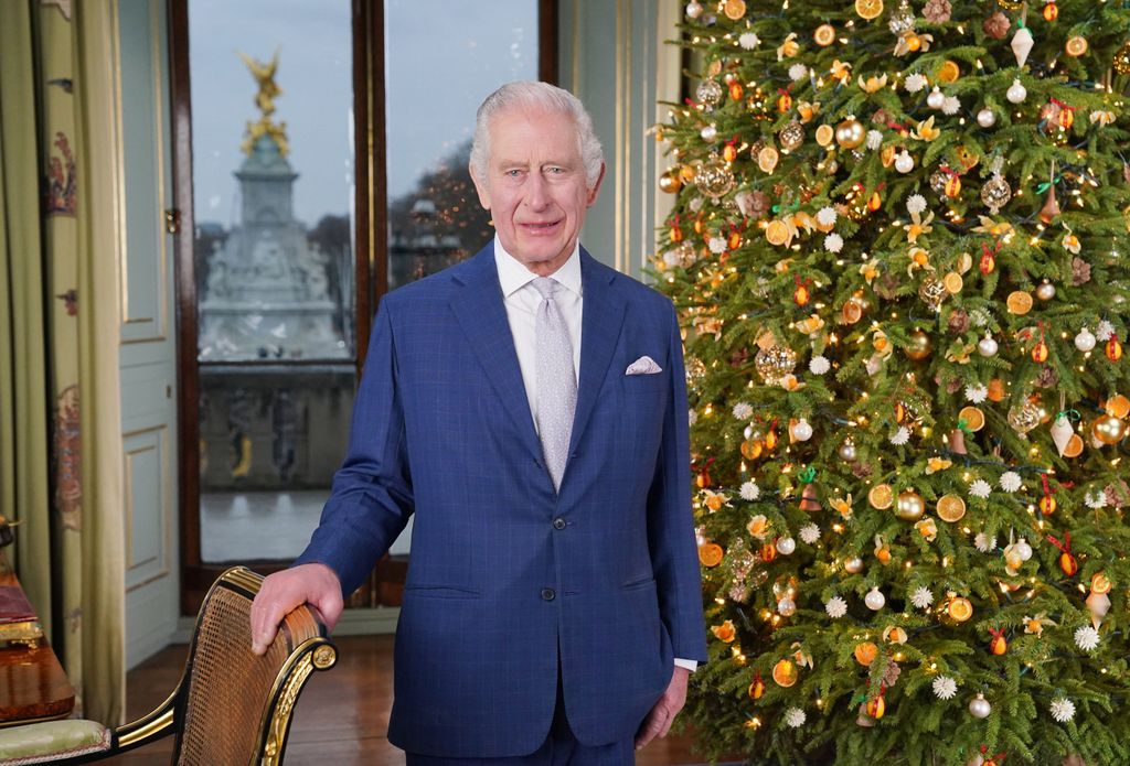 King Charles in front of a Christmas tree